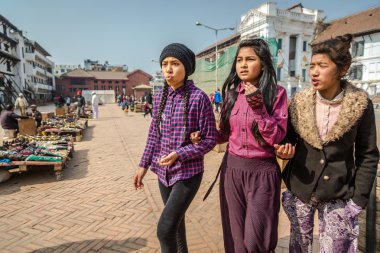 Local girls walking in the Durbar square clipart