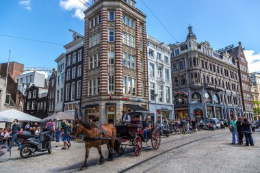 Group of tourists and locals walking in streets