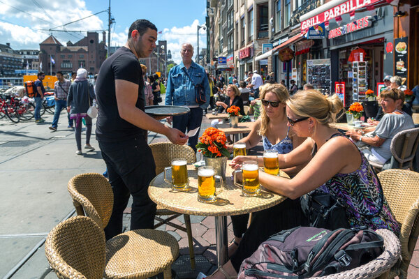Tourists enjoying drinks in downtown Amsterdam