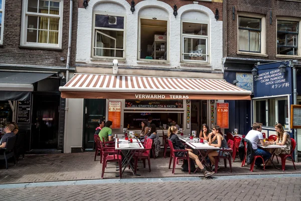 Tourists and locals enjoying restaurants of Amsterdam