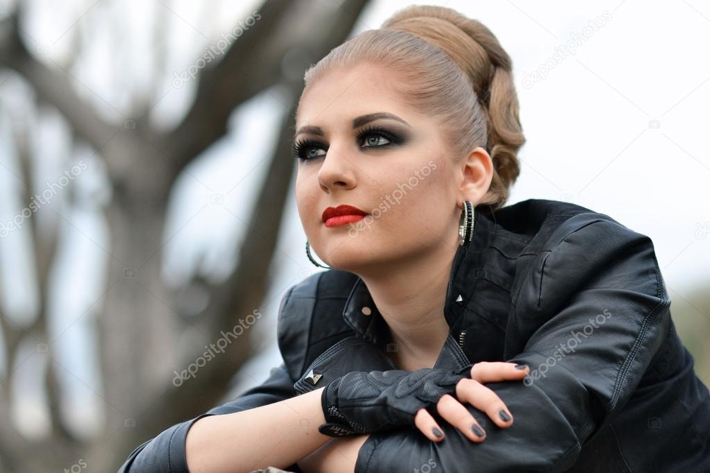 Biker Chick in Front of Motorcycle. Beautiful and Pert Young Woman in  Leather Clothes. Stock Image - Image of girl, colouring: 148605931