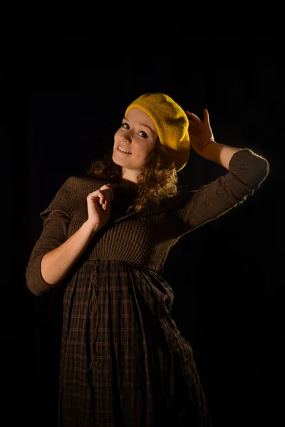 Beautiful, fashionable, glamorous, nice, attractive,pretty,nice,cheerful,smiling,parisian girl,woman,student,teenager,lady with cite smile,face,well-dressed and yellow beret,cap,gesture,pose,posing.Portrait.Black background.Photo studio.Paris,manners — 图库照片