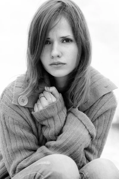 New cover of the glam magazine.Black-and-white photo.Depressed,unhappy,sad glamorous,fashionable girl warm up with sweater,cold weather.Feelings,pain in her eyes.Very upset,sad and depressed,but attractive,nice girl wrapped up warm sweater,pullover. — Stock Photo, Image