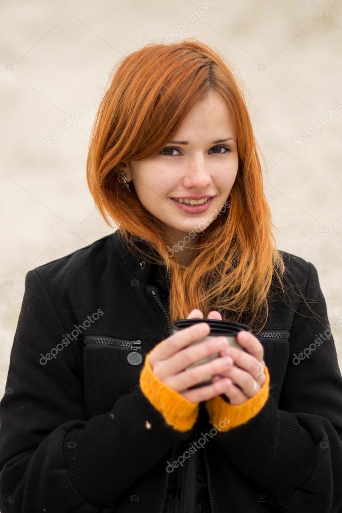 Beautiful Red Haired Girl In A Black Fashionable Coat Trying To