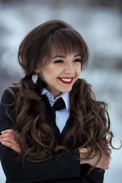 Attractive student.Beautiful,attractive,adorable,nice,pretty girl,model with curly,wavy hair,perfect hairstyle and make-up,healthy,white,cute smile. The most beautiful smile in the world. Toothpaste advertizing. The happy girl looks aside and laughs. — Stock Photo, Image