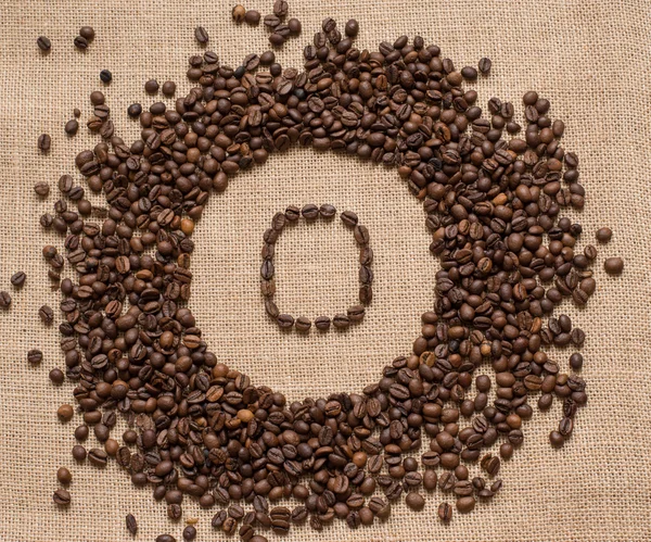 Numbers from coffee beans on burlap background — Stock Photo, Image