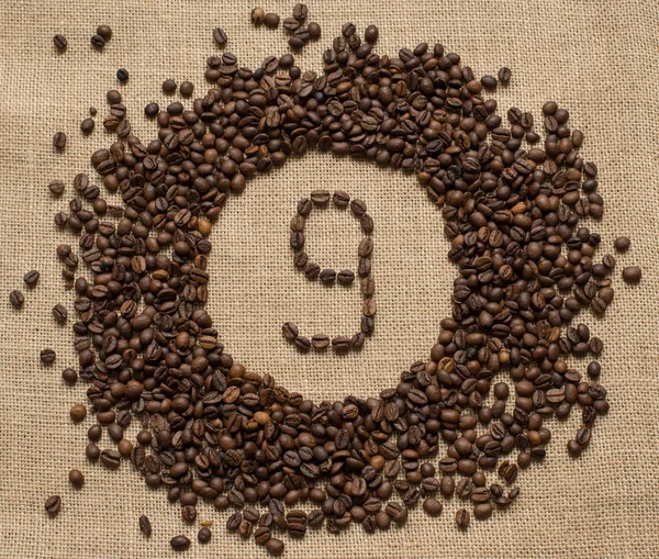 Numbers from coffee beans on burlap background — Stock Photo, Image
