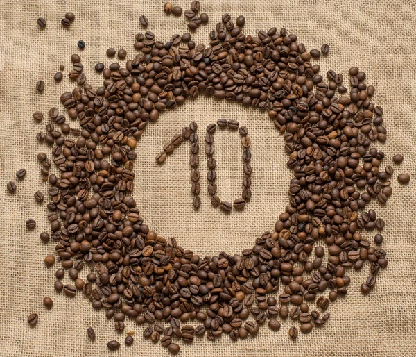 Numbers from coffee beans on burlap background — Stock Photo, Image