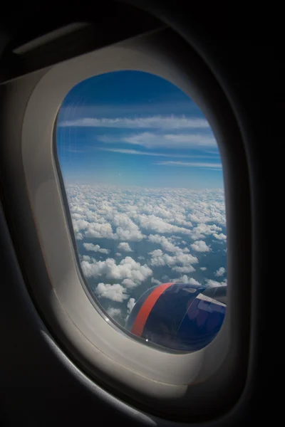 Nuages et ciel vus à travers la fenêtre d'un aéronef — Photo