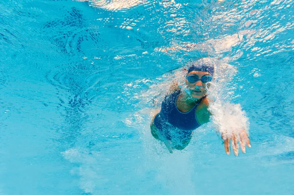 Front crawl swimmer breaking the surface