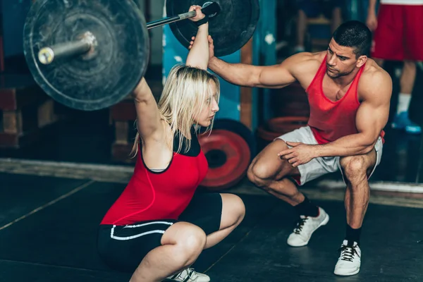 Female weightlifting training with trainer — Stock Photo, Image