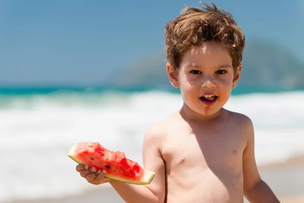 Cute little boy eating watermelon — Stock Photo, Image