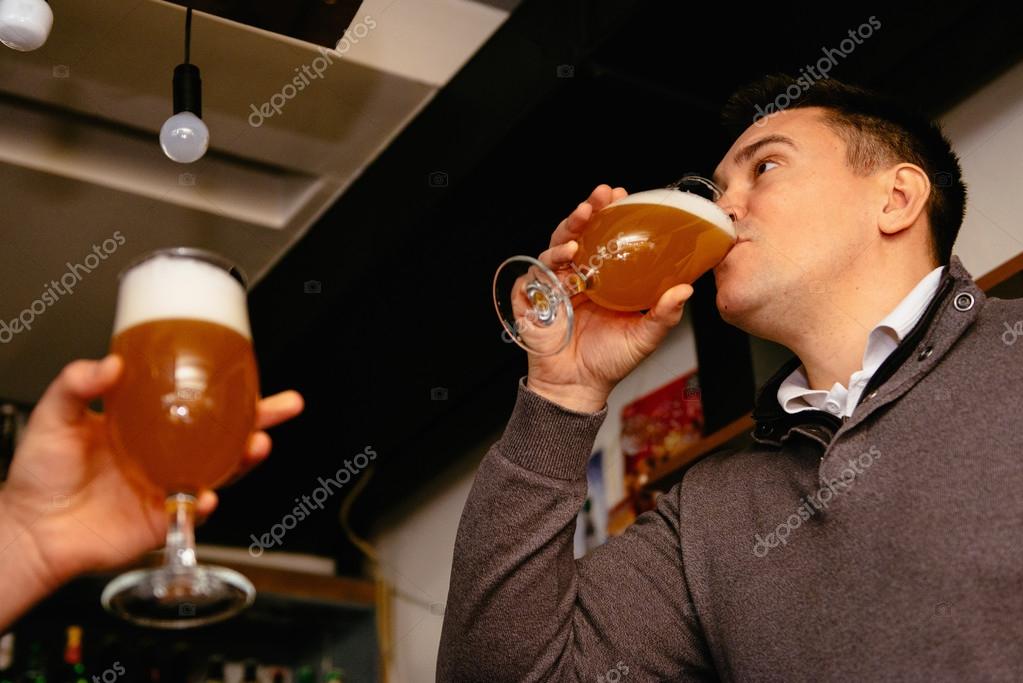Colleagues drinking beer after work Stock Photo by ©microgen 115107848