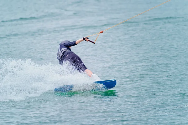 Wakeboarder performing  sharp turn