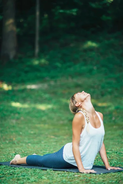 Girl doing Cobra Position — Stock Photo, Image