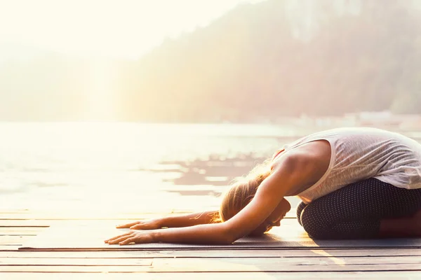 Woman practicing Balasana — Stock Image Woman practicing Balasana Stock Image