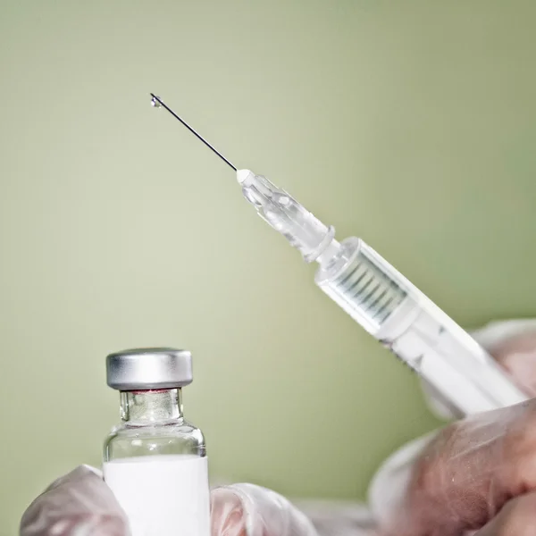 Doctor hands holding syringe — Stock Photo, Image