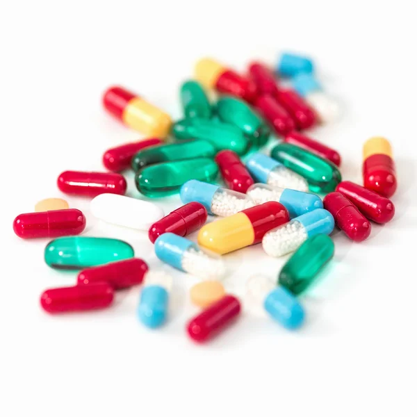 Variety of pills on white table — Stock Photo, Image