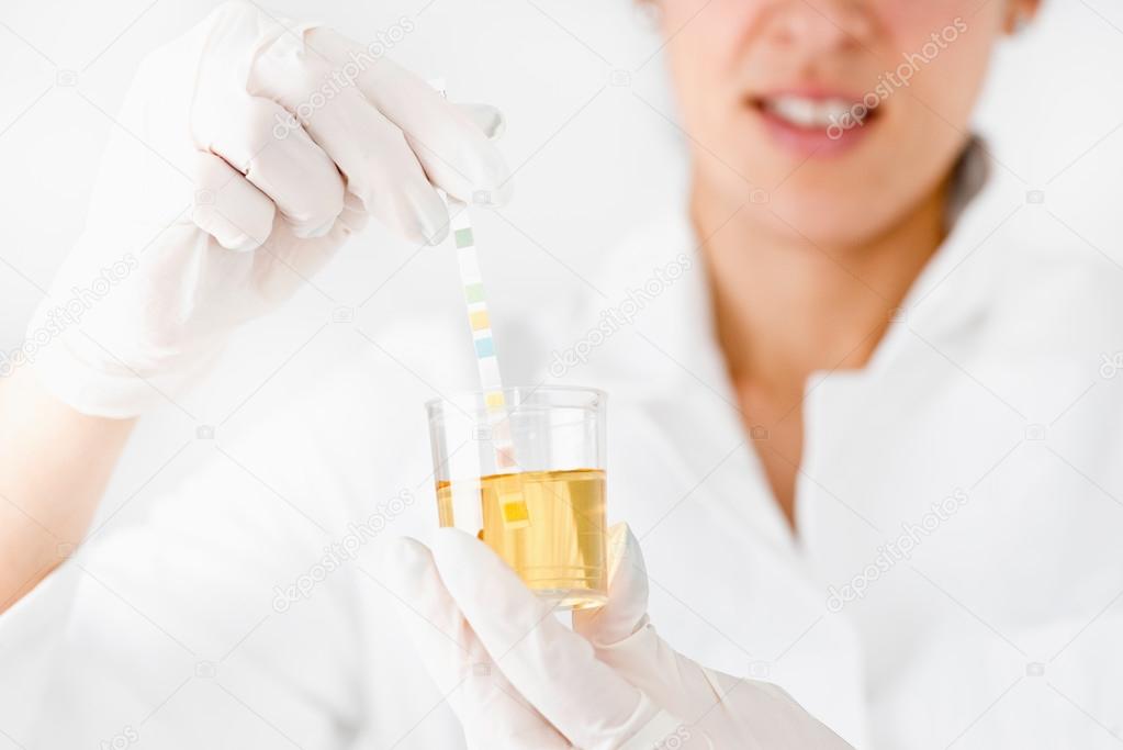 Medical worker testing urine sample