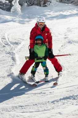 father and son Skiing  clipart