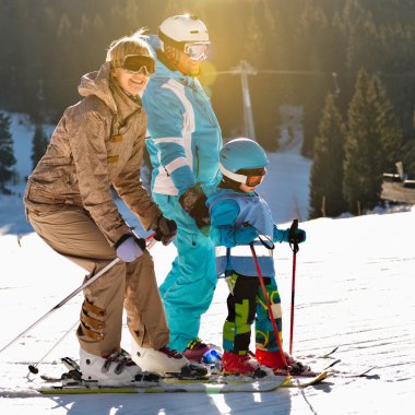 Family skiing on winter vacation clipart