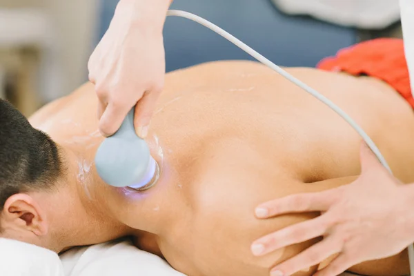 female therapist doing ultrasound shoulders therapy