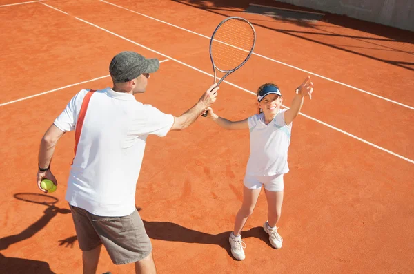 Entrenamiento de niña con instructor de tenis — Foto de Stock