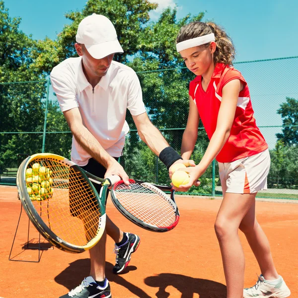 Tennis instructor with Junior player — Stock Photo © microgen 115174014