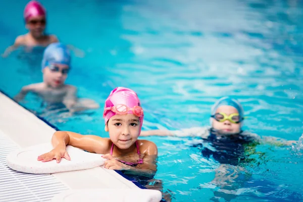 Cool kids in swimming pool — Stock Photo, Image