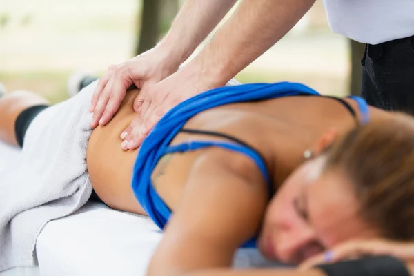 Atleta femenina en mesa de masaje —  Fotos de Stock