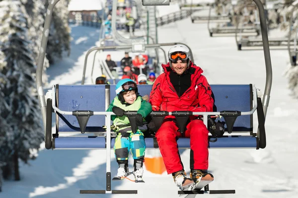 Father and son on ski lift Stock Photo