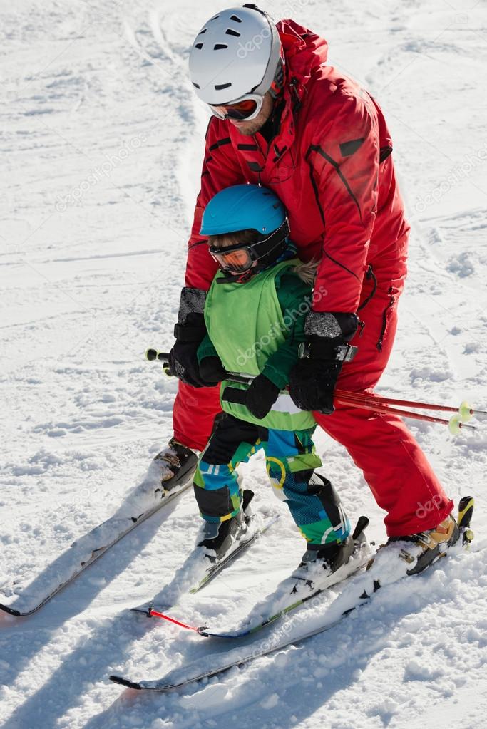 Ski instructor with little boy