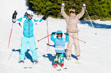 Cheerful family skiing  clipart