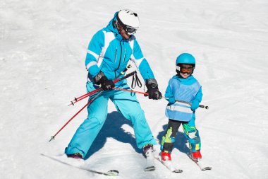 little boy skiing with instructor clipart