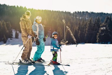 Skiing family on the mountain clipart