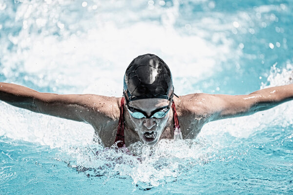 sportswoman swimming butterfly stroke
