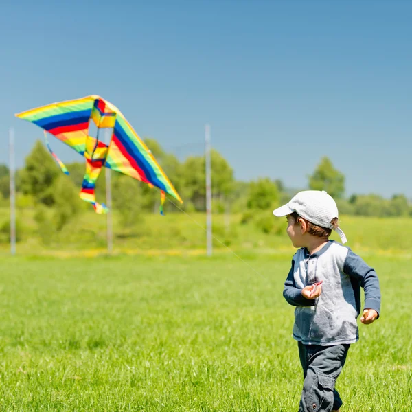 Menino correndo com papagaio — Fotografia de Stock