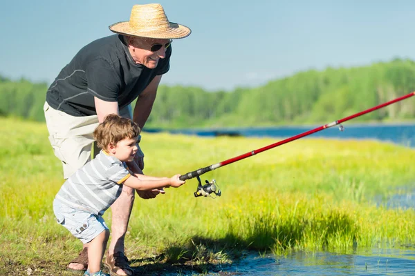 Grandson fishing with grandfather — Stock Photo, Image