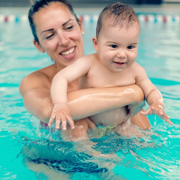 Mother with baby in the swimming pool Royalty Free Stock Photos