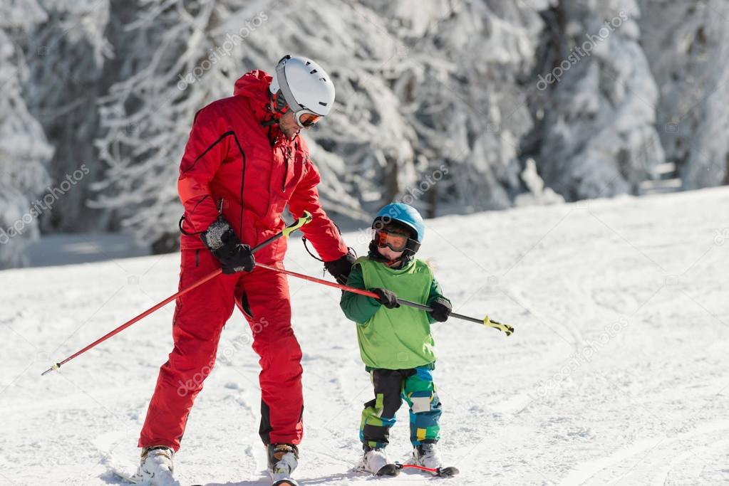 Skiing instructor working with boy