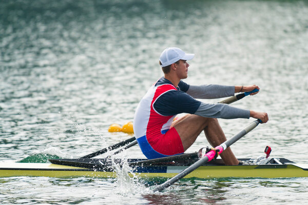 athlete rowing single scull