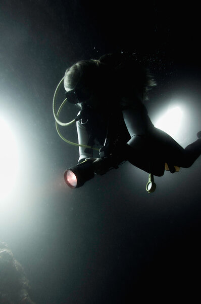 Scuba diver exploring underwater cave