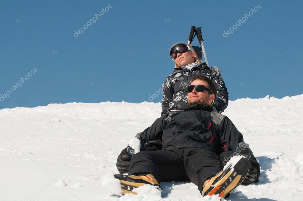 beautiful couple sunbathing in snow