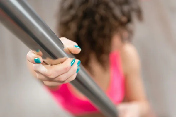 Sensual woman holding pole