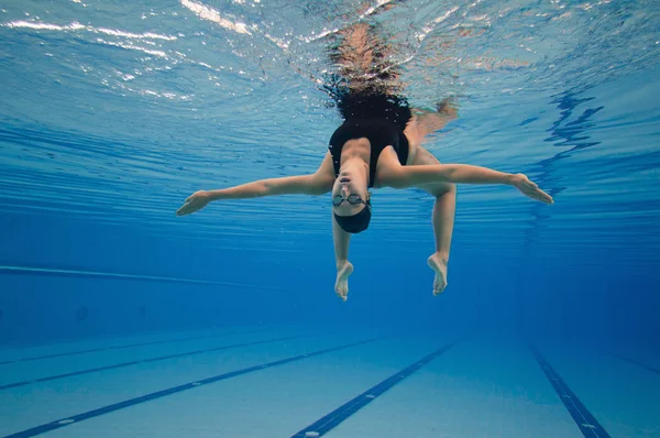 Synchronized swimmer performing underwater — Stock Photo, Image