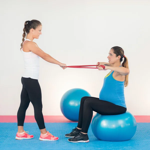 Pregnant woman doing simple resistance band — Stock Photo, Image