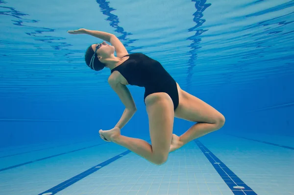 Synchronized swimmer performing underwater — Stock Photo, Image