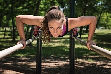 athlete doing push-ups on bars clipart