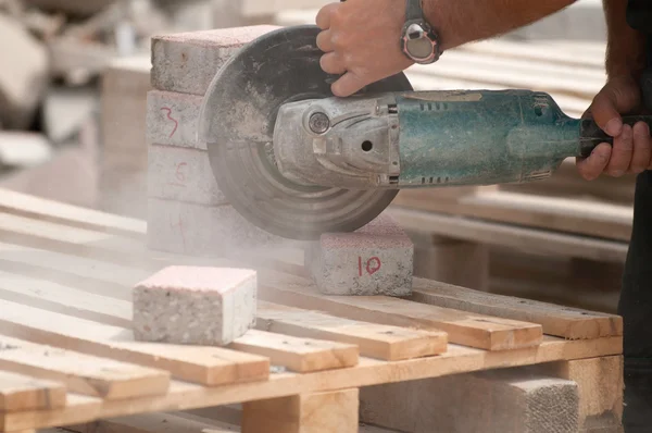 Worker cutting street tile blocks — Stock Photo, Image