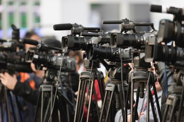 row of TV cameras at public event